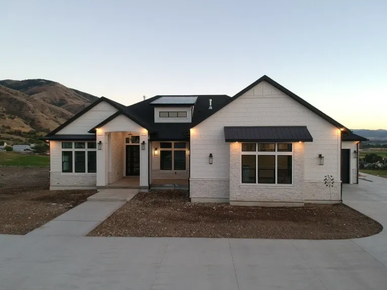 Single-story craftsman at dusk with mountains behind